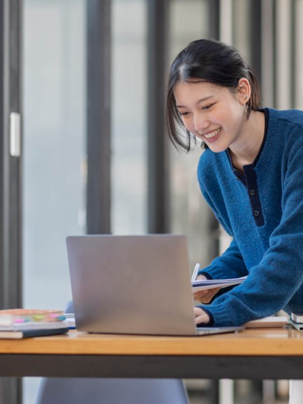 business-asian-woman-using-laptop-computer-and-working-at-office-with-calculator-document-on-desk-.jpg