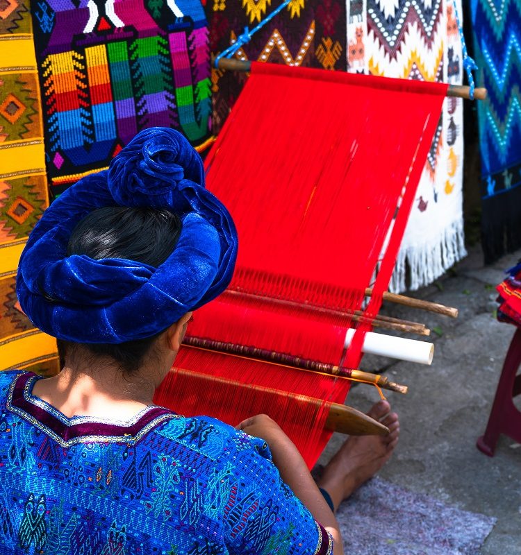 A Mayan woman weaving a tablecloth with her waist loom in San Antonio Palopo, Guatemala