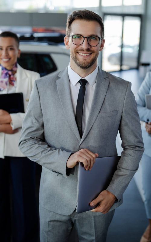 salesteam-in-dealership-three-beautiful-consultants-or-managers-in-elegant-suit-looking-on-camera-.jpg